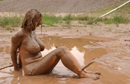 Naked women bathe in the mud