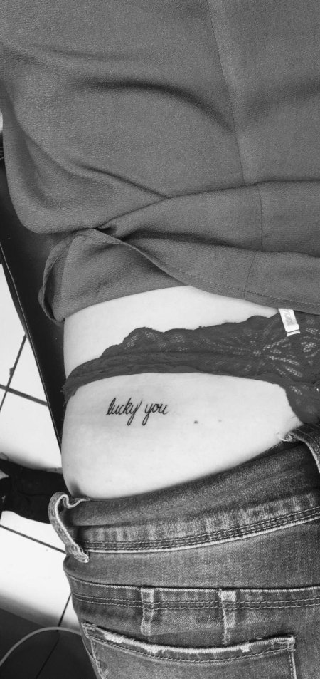 Tattoo inscription on the thigh