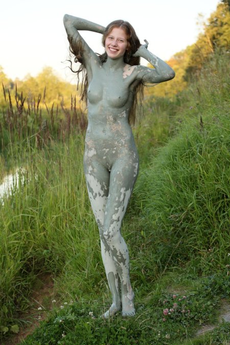 Naked in therapeutic mud