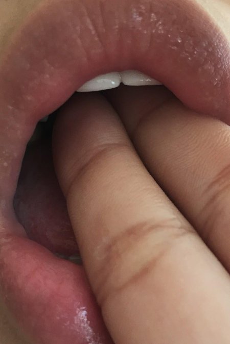 Finger in her mouth