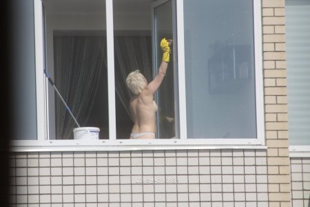 Naked women in the windows of houses