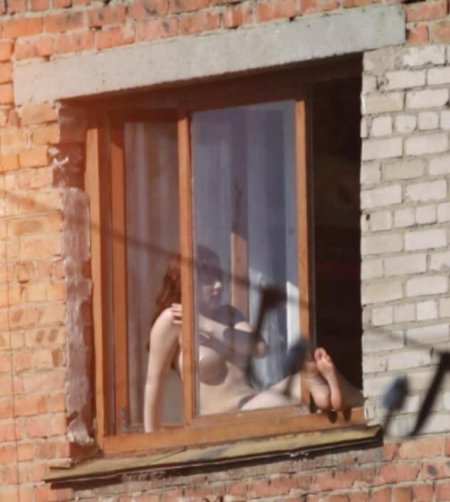 Peeping out the windows behind naked