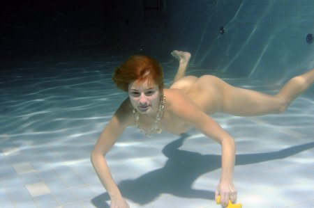 Naked women swim in water